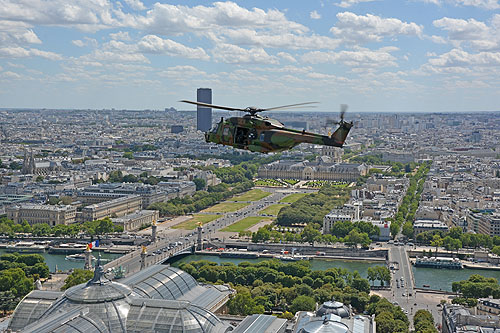 Hélicoptère NH90 au-dessus du Grand Palais, avec les Invalides et la Tour Montparnasse au fond