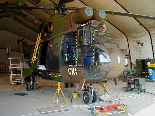 Hélicoptère Puma en maintenance, la tente de campagne remplace le hangar de la base